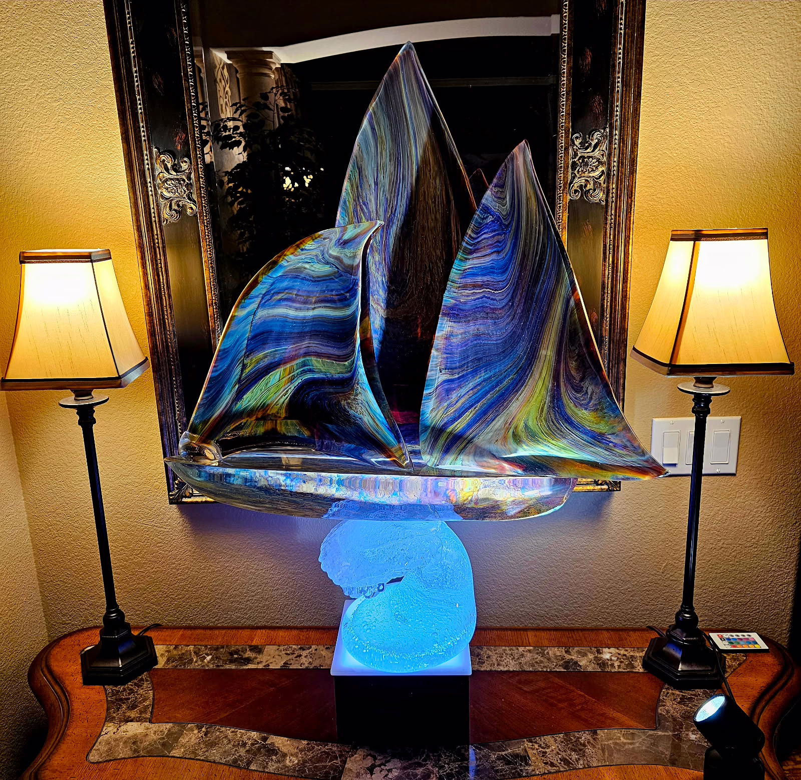 LED display shelving illuminating sculptural glass artwork in a residential display setting