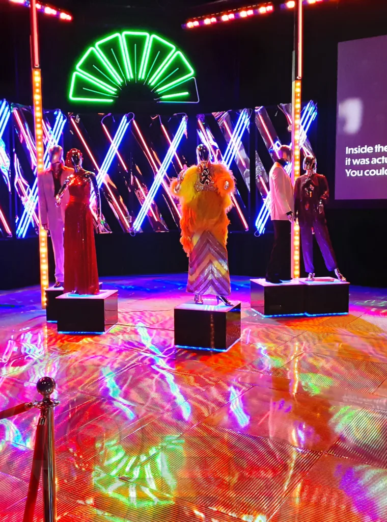 Custom LED display bases used in Andy Warhol exhibit installation with mannequins and colorful lighting