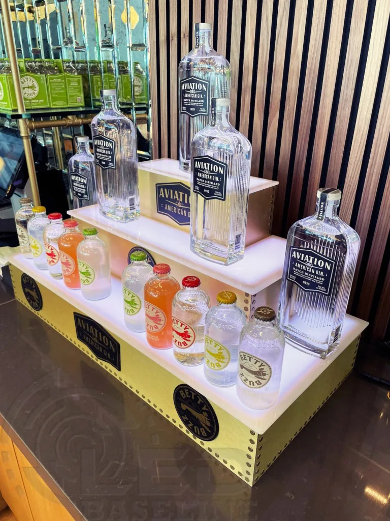 LED illuminated bottle display featuring Aviation Gin bottles in the First Officers Lounge at JFK Airport